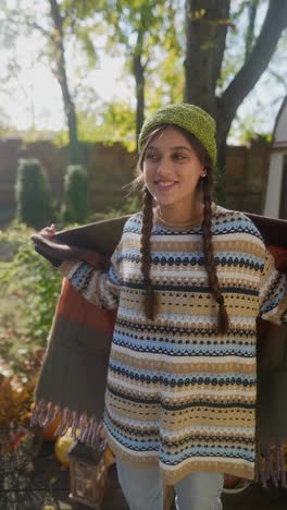 young woman enjoying a fall day in a garden