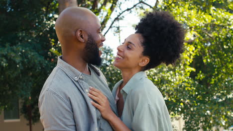 Portrait-Of-Loving-Couple-Standing-Outdoors-In-Garden-Park-Or-Countryside