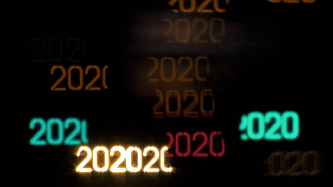 Colorful year 2020 shaped bokeh from moving car and traffic lights at the evening, Happy New Year or holiday concept background, copyspace