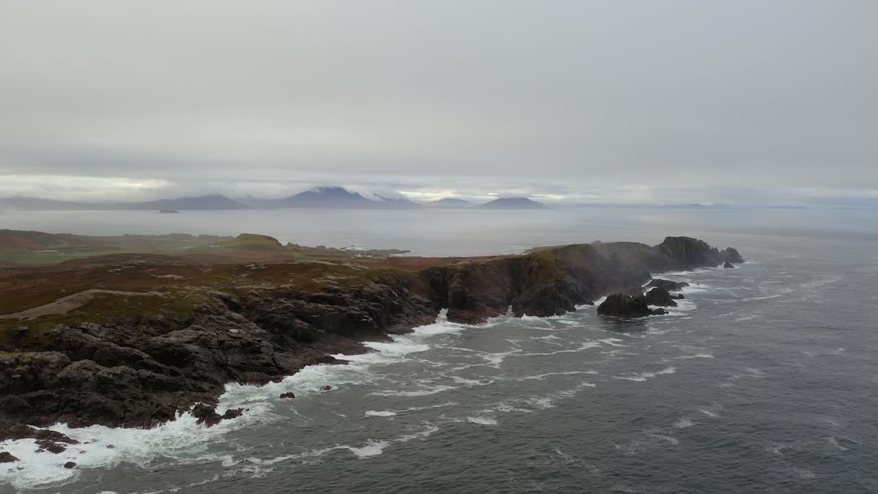 AAerial Ascend of Malin Head’s Rugged Coast on a Foggy Morning