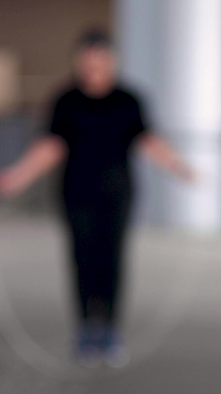 Person jump roping steadily in an urban setting