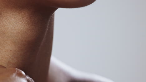 close-up of a person's neck and hand