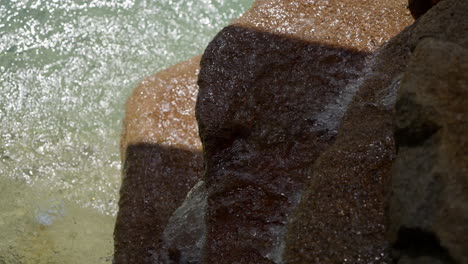 running water into over rock into outdoor pool rock fountain
close up