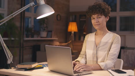 woman working on laptop at night