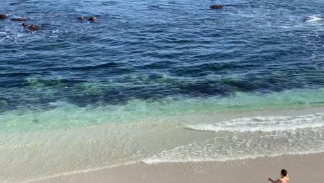 A-little-boy-skipping-happily-into-the-water