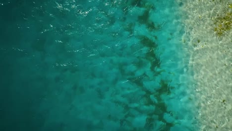 from the top view over a blue caribbean sea in los roques, venezuela