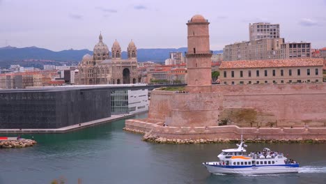 boats enter and exit the harbor in marseilles france 2