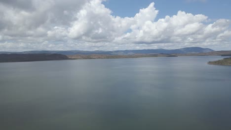calm waters of morey reef with fluffy white clouds in the sky near port douglas in qld, australia