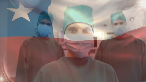 Animation-of-waving-chile-flag-against-portrait-of-team-of-diverse-surgeons-at-hospital