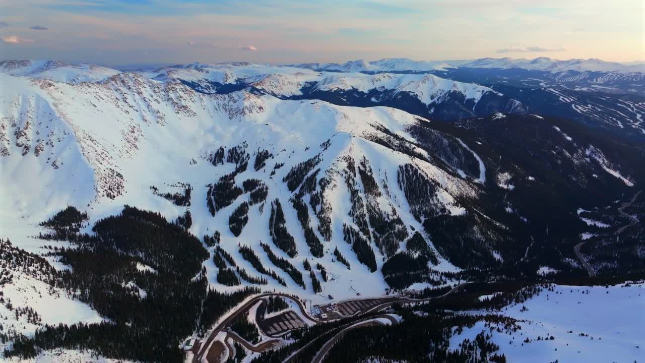 Spring winter sunset golden hour at A-BayArapahoe Basin Loveland Pass windy road aerial drone Colorado car parking lot lodge trail runs Breckenridge Keystone ski resort Summit County circle left