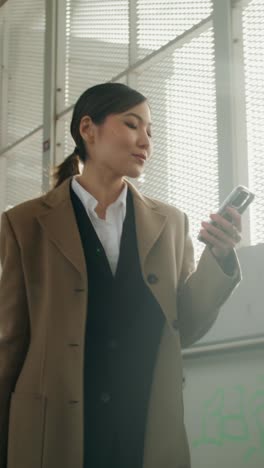 woman in business attire using phone