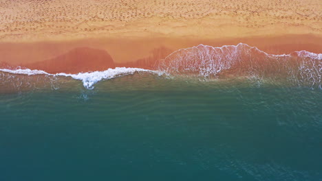 strong ocean waves breaking on tropical sandy beach in thailand