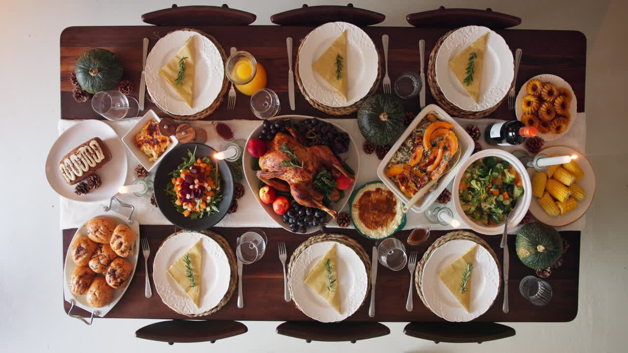 Thanksgiving dinner table setting with roasted turkey and autumn harvest dishes
