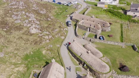 Descending-drone-shot-of-the-Gearrannan-Blackhouse-Village-on-the-Isle-of-Lewis,-part-of-the-Outer-Hebrides-of-Scotland