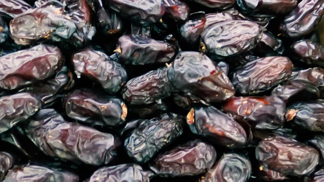 Date fruits or date palm. Heap of date fruits in a super shop smooth slide motion.Fresh healthy fruit.