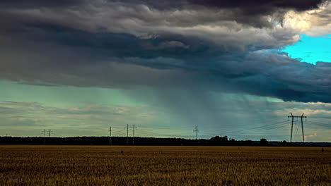 rain and storm clouds gather and spread across open farmland field, dark grey moody, time lapse