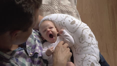 grandfather tickling newborn baby girl