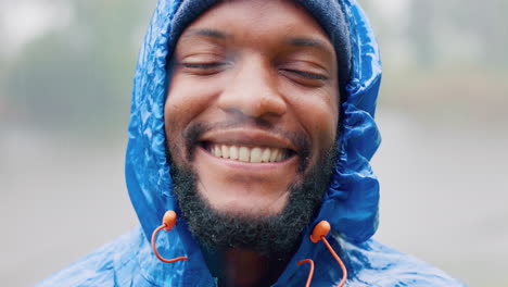 face, happy and a black man hiking in the rain