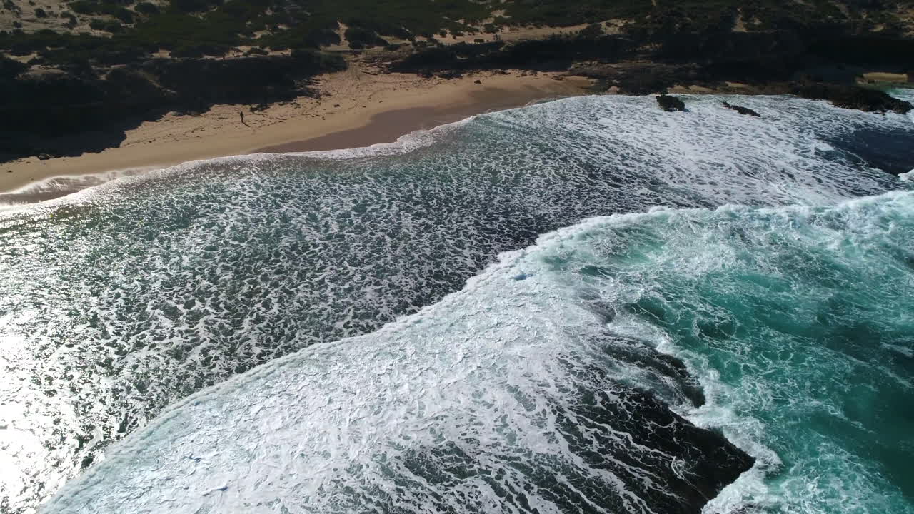 drone sobre la playa mientras las olas chocan contra la línea de la costa en pearses beach, victoria