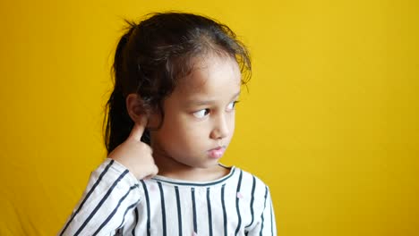 child girl having ear pain touching his painful ear ,