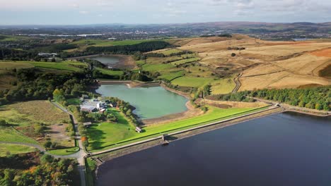 high up aerial drone video footage taken at ogden saddleworth moor in oldham, england of a series of lakes, reservoirs, set against a backdrop of moorland, woodlands and farmland pastures