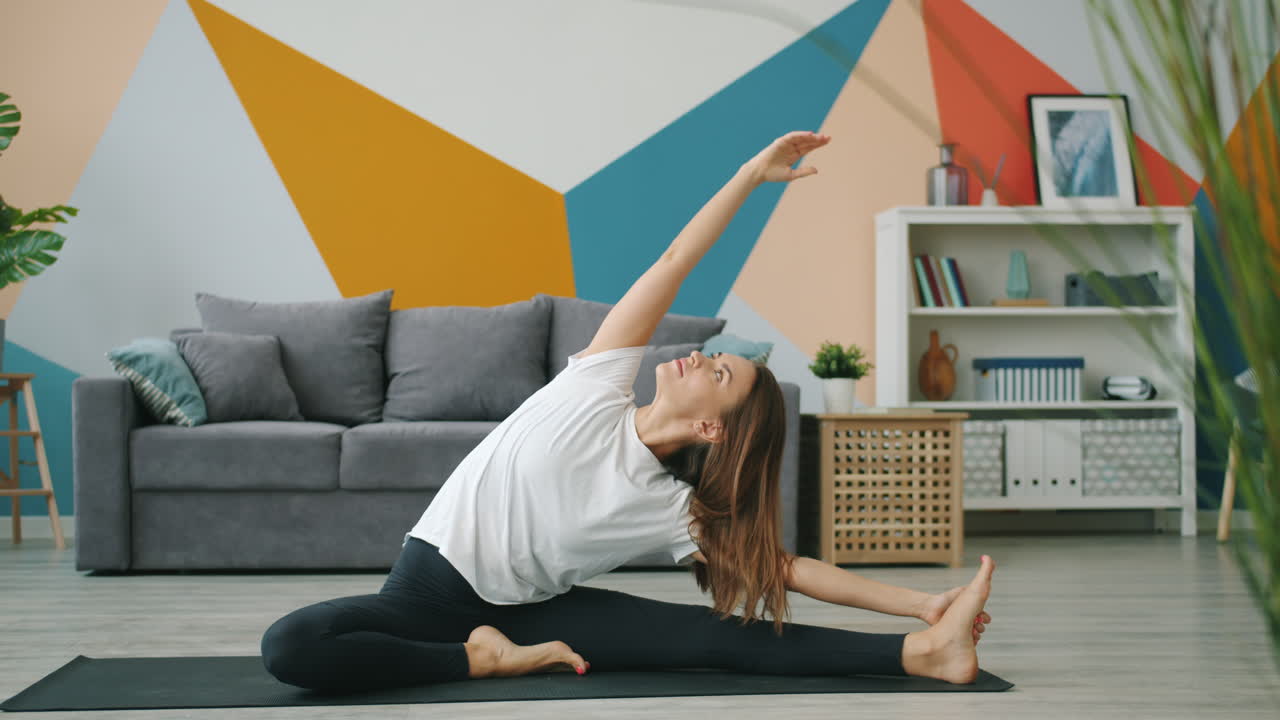 Woman Performing a Side Stretch Yoga Pose at Home