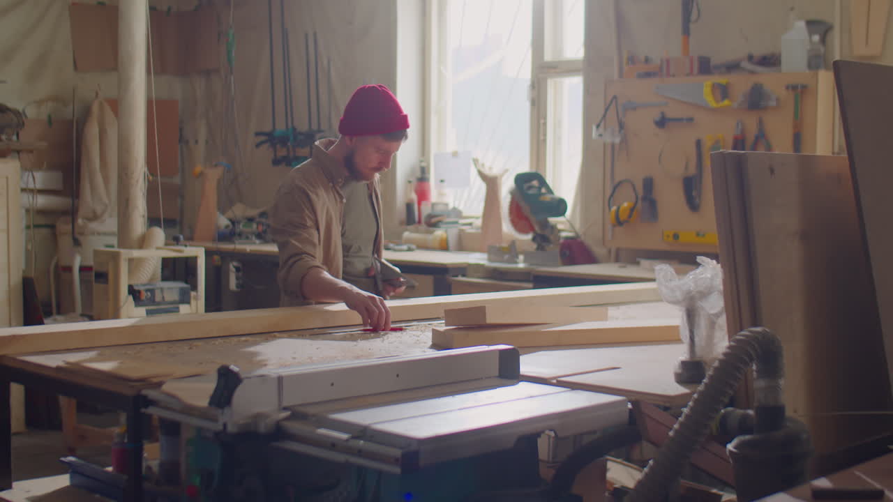 Woodworker Taking Measurements of Plank in Workshop