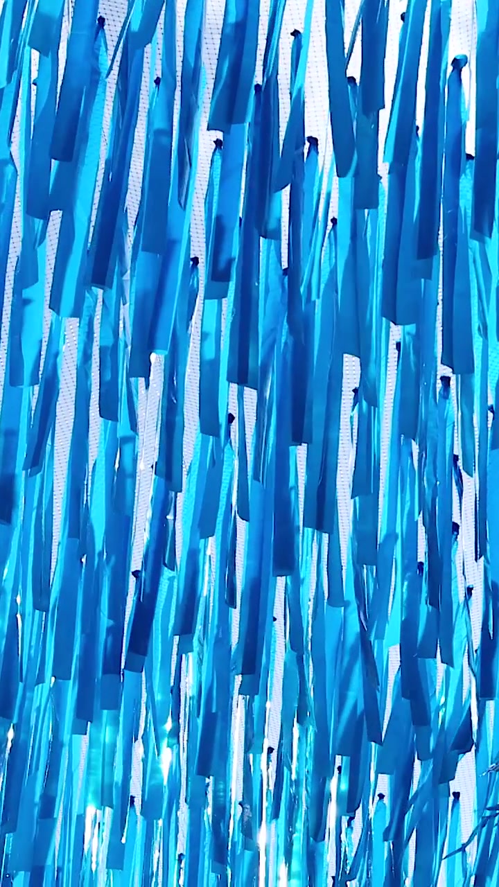 Vibrant blue streamers flutter in the breeze
