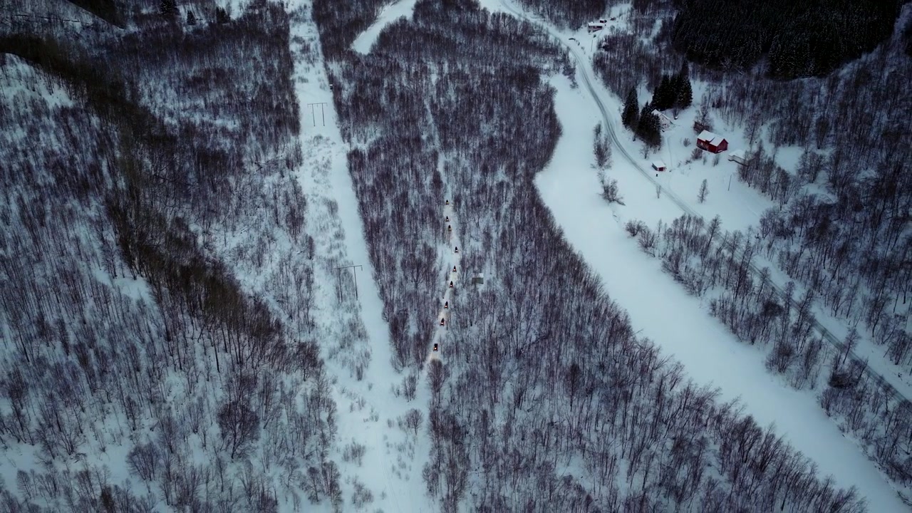 Escursione di ecoturismo in motoslitta a Tromso attraverso un paesaggio innevato, vista aerea dall'alto