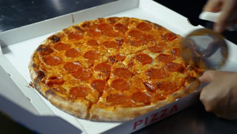pepperoni pizza being cut and served