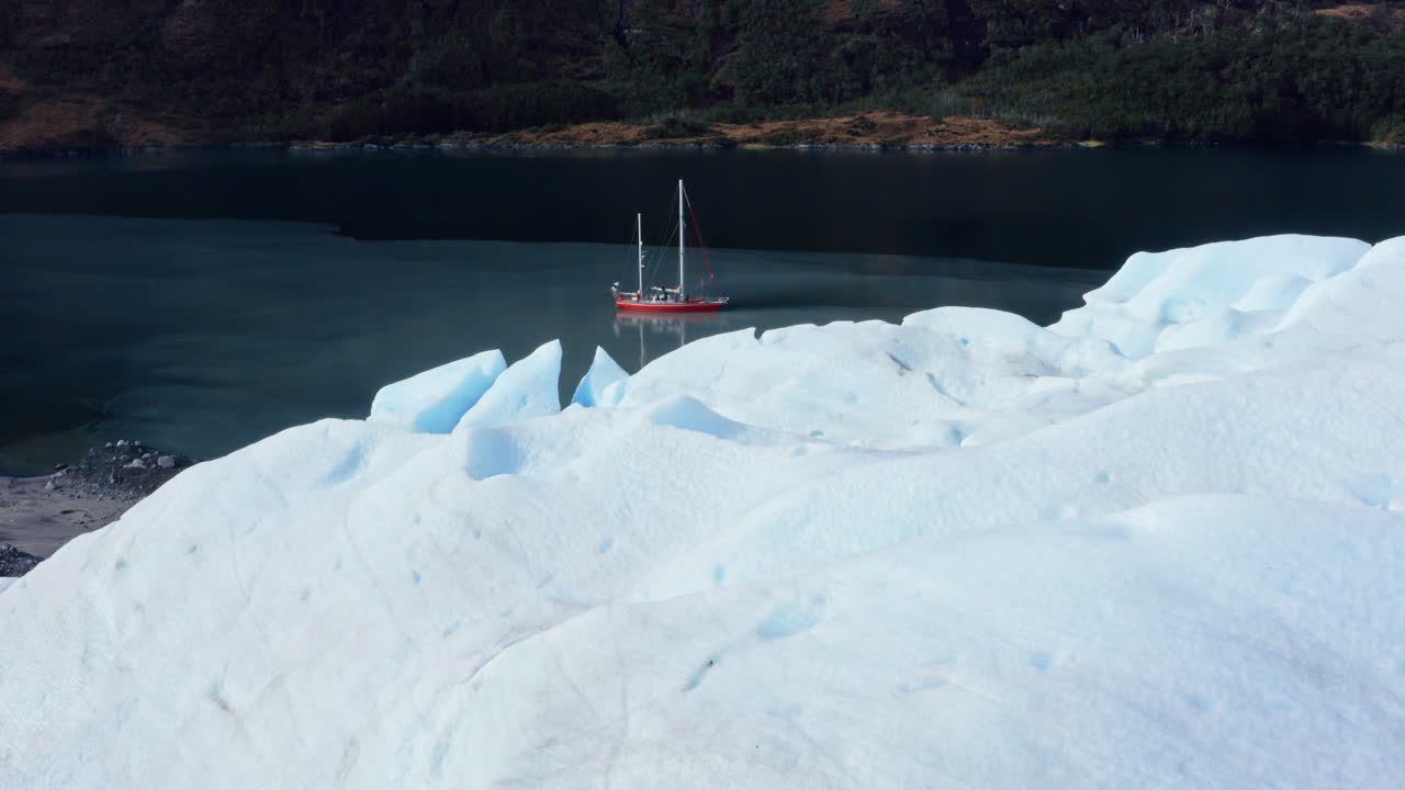 Flying Over The Glacier Revealing The Boat Navigating In The Beagle Channel In South America. - aerial shot