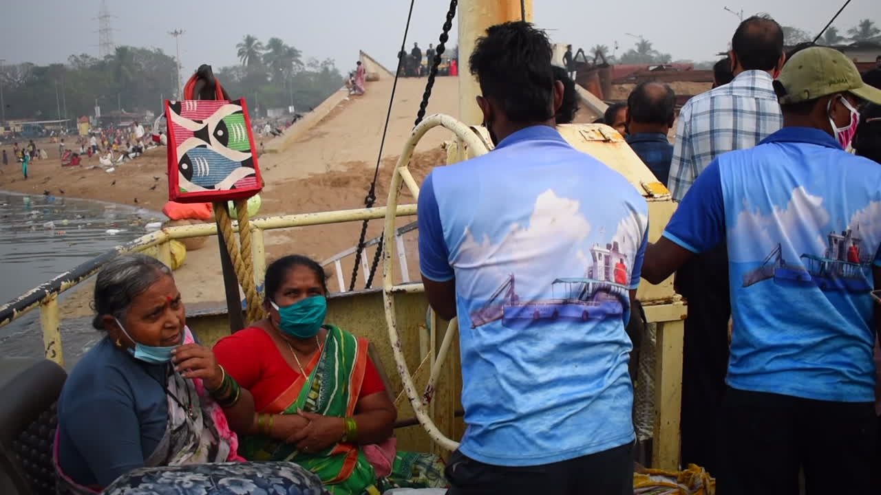 A person turning and rotating wheel of a ferry boat preparing to leave port or dock or jetty in Mumbai, India, video background in prores 422 HQ