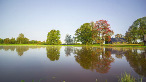 Spring,-summer,-autumn,-and-winter-all-year-time-lapse-of-a-cabin-by-a-lake