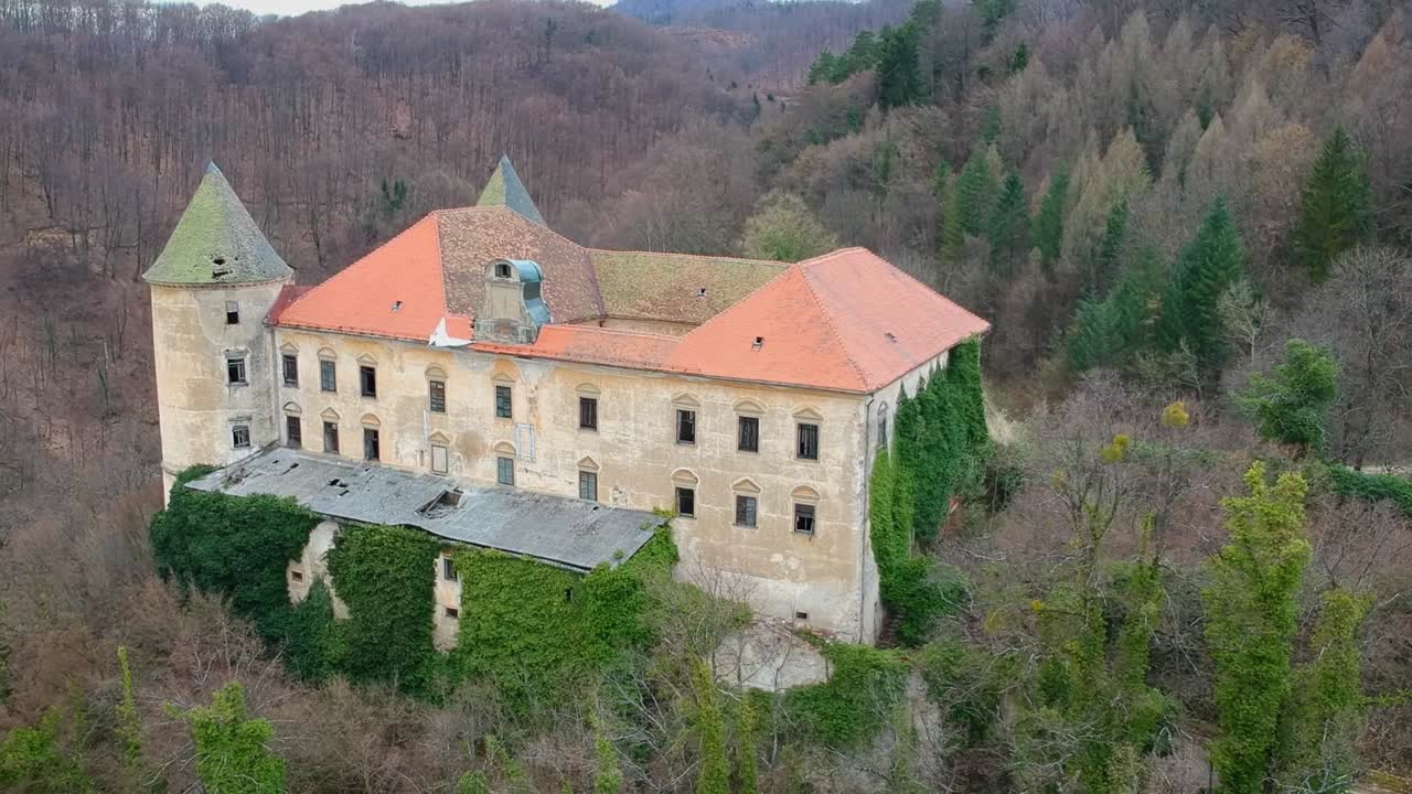Aerial trucking shot of abandoned Podčetrtek Castle in Slovenia