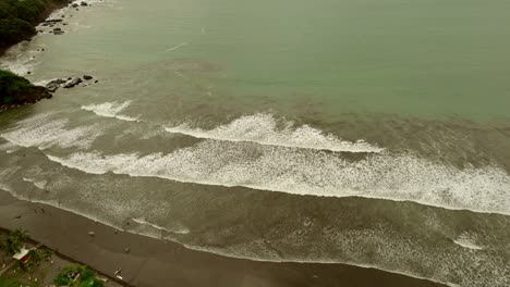 vast beaches and sea with waves rolling onto shore in costa rica