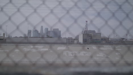 downtown los angeles through a wire fence with a focus pull, california usa.