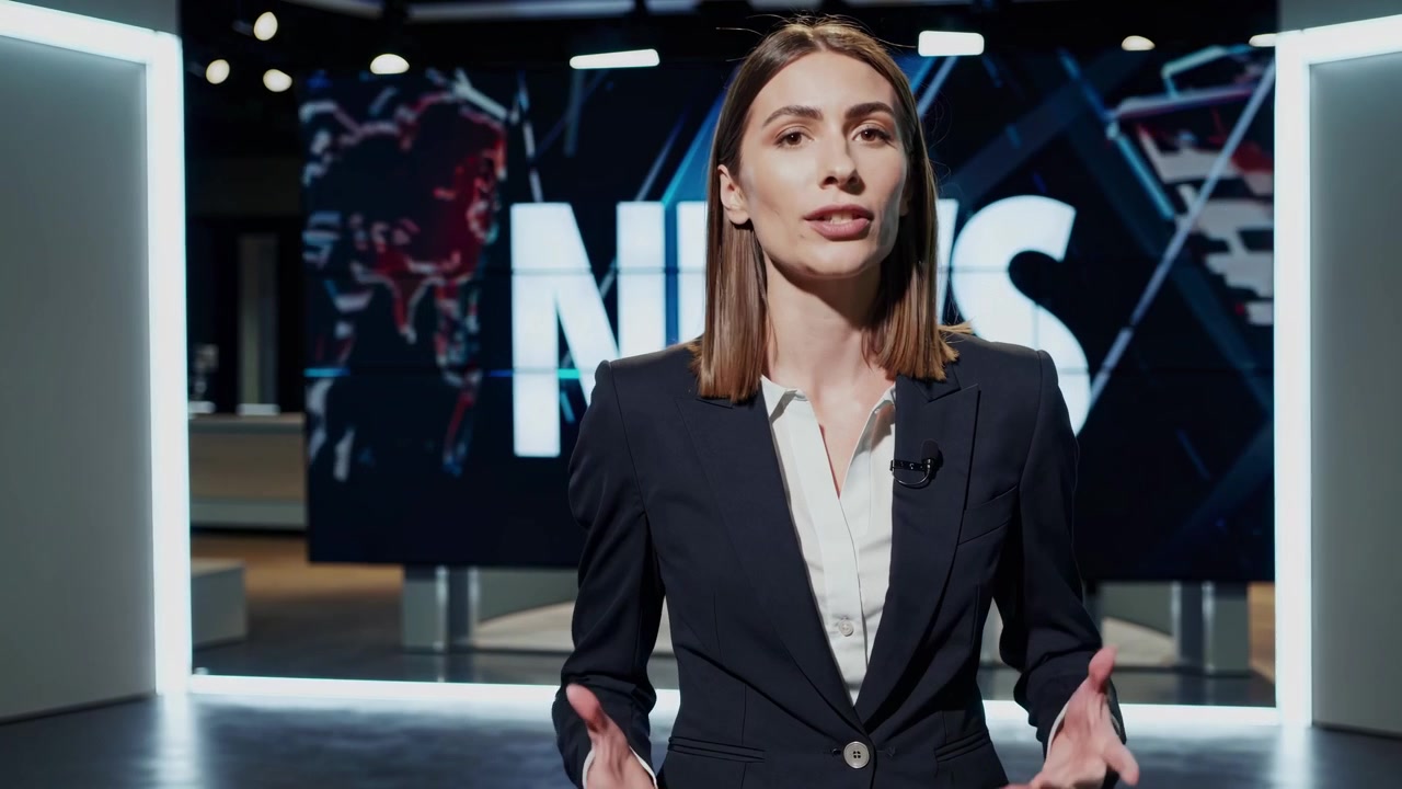 Female News Anchor Speaking in Modern Television Studio