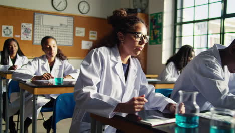 estudiantes en una clase de ciencias trabajando en un experimento