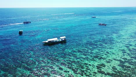 Seychelles-aerial-seascape-with-boats-and-perfectly-healthy-coral-reef,-tropical-vacation-concept