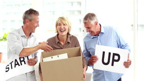 casual business-people holding signs