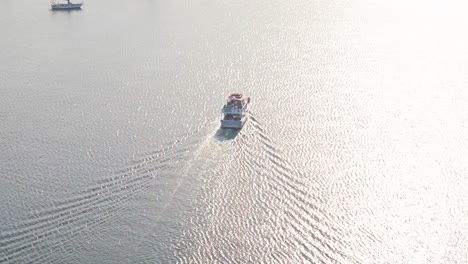 high angle view of large boat at sunrise in calm waters reflecting light