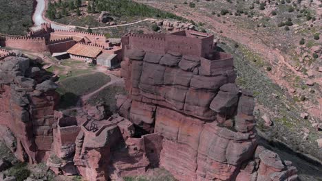 aerial drone view of the castle of peracense, in teruel , bulit in the x century with red sandstone in the top of a hill