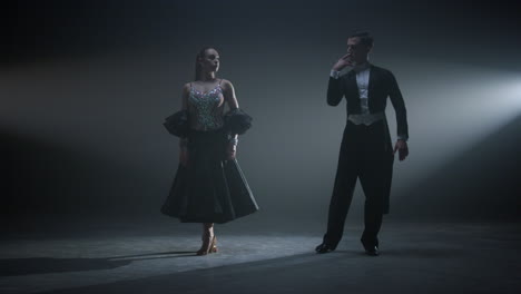Dance-couple-bowing-after-performance.-Ballroom-dancers-standing-on-stage.