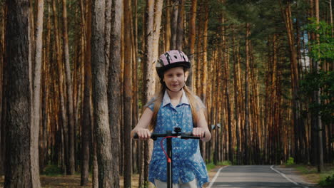 Joyful-Child-Rides-An-Electric-Scooter-On-The-Road-In-The-Park