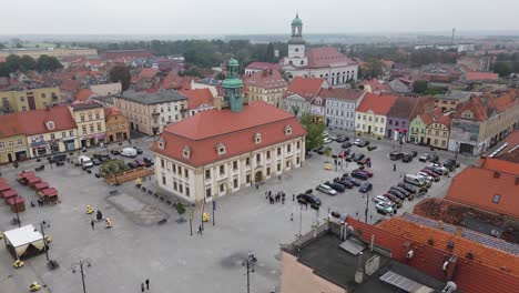 old-town-hall-in-square-town-square-aerial-circulating-urban-bird-pigeons