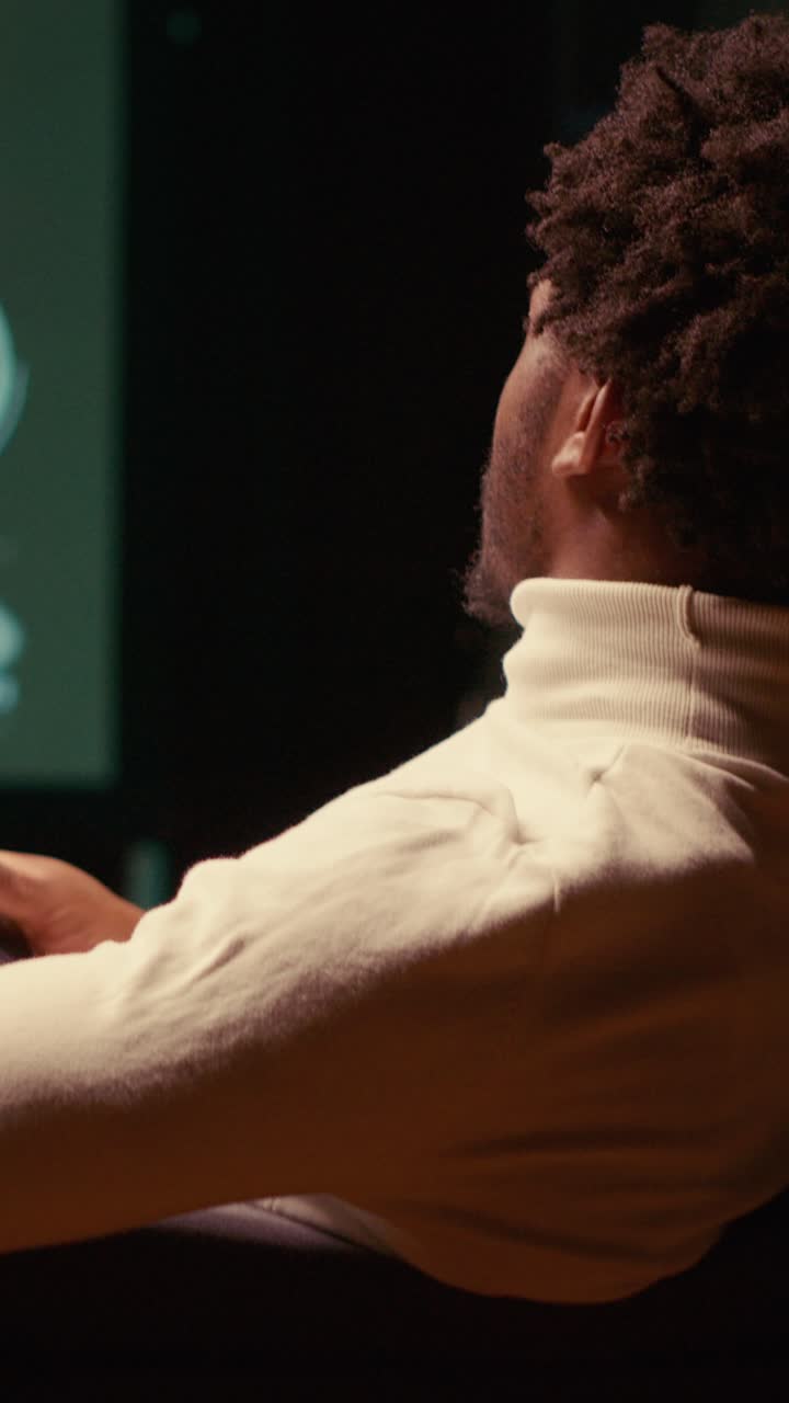 Vertical video Close up of gamer enjoying PvP fps online multiplayer game on TV