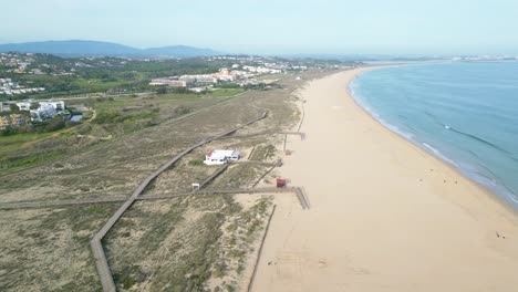 Praia de são roque beach in lagos, portugal, with dunes and coastline, aerial view