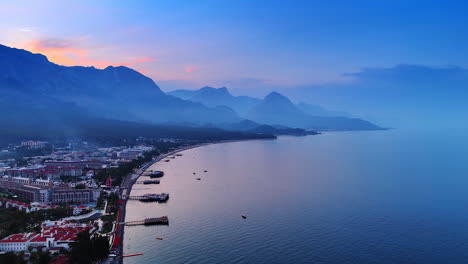 Beautiful resort area with beaches and berths on the water. Silhouettes of the mountains at backdrop. The Mediterranean, Turkey