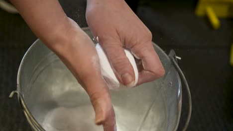 man coating his hand with chalk powder