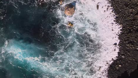 spectacular aerial view captures the delicate encounter of calm ocean waves with the smooth cliffs of big island, hawaii